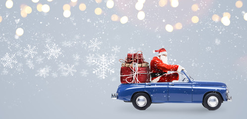 Santa Claus on car delivering Christmas or New Year gifts at snowy gray background - 182521082