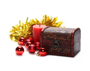 Wooden jewelry gift box, treasure chest with red ball and golden tinsel isolated on white background