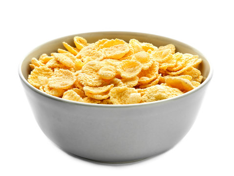 Bowl with tasty corn flakes on white background