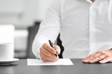 Businessman signing document in office