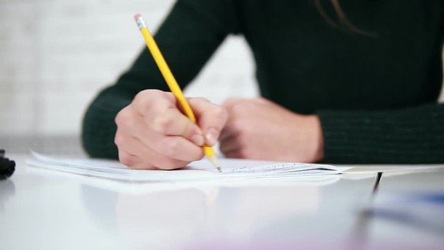 Human woman's hands with pencil writing erase and rewrite words
