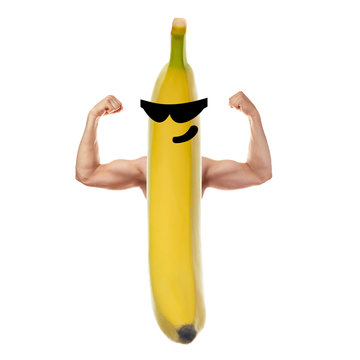 Smiling face on banana with muscular arms. Concept of healthy lifestyle, diet
