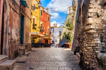 colorful south italy village alley in Apulia in the town of Vico del Gargano - Powered by Adobe