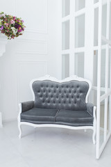 Grey sofa on a white wall background