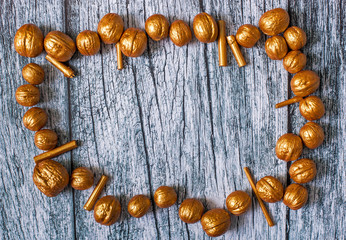 Gold nuts and gilt sticks on the background of old wooden panels, Christmas and New year background