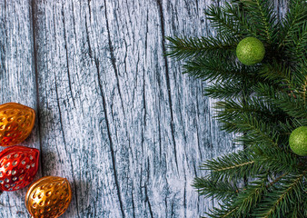 Branches of spruce with Christmas decorations on a background of old wooden panels, Christmas and New year background