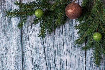 Branches of spruce with Christmas decorations on a background of old wooden panels, Christmas and New year background