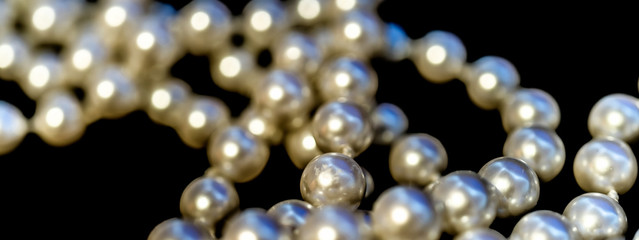 Abstract picture of a pearl necklace, front and rear intentionally blurred