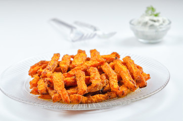 Homemade organic pumpkin with sour cream sauce. Traditional autumn dishes from pumpkin. Fried baked on grill pumpkin with spices and olive oil.