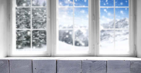 Plakat winter window and white wooden desk space 