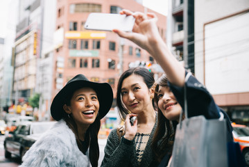 Group of japanese women spending time in Tokyo, making shopping in differents areas of the city
