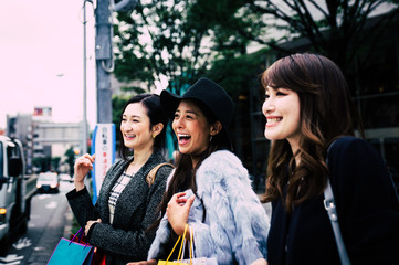 Group of japanese women spending time in Tokyo, making shopping in differents areas of the city