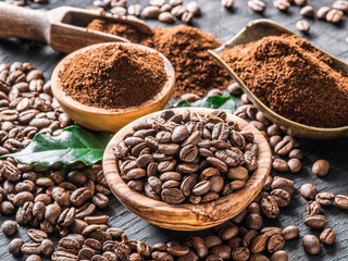 Roasted coffee beans  and ground coffee on wooden table. Top view.