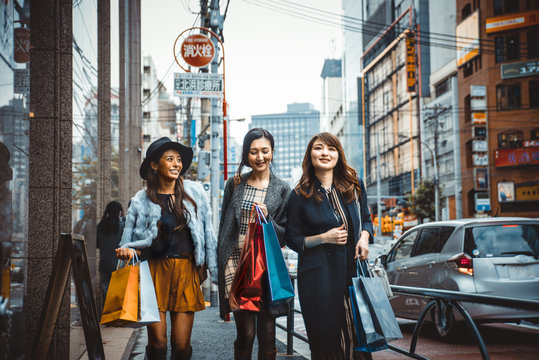 Group of japanese women spending time in Tokyo, making shopping in differents areas of the city