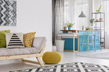 Yellow pouf in spacious room
