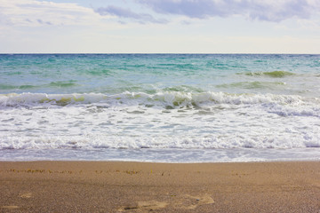 Stormy winter Mediterranean sea and empty sandy beach