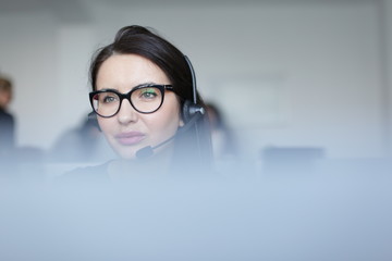 Focused girl in call center wearing headset