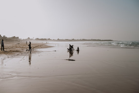 Black youth spending time on ocean shoreline