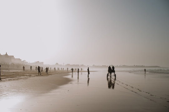 Beach in haze with people spending time