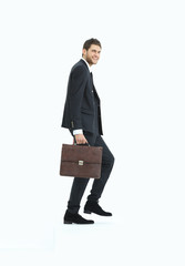 in full growth. a businessman with a leather briefcase walks up.