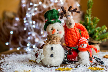 Handmade yarn snowman holding gifts in a sock, boot.