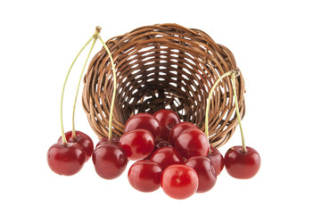 red cherry in a wicker basket isolated on a white background