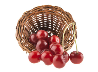 red cherry in a wicker basket isolated on a white background