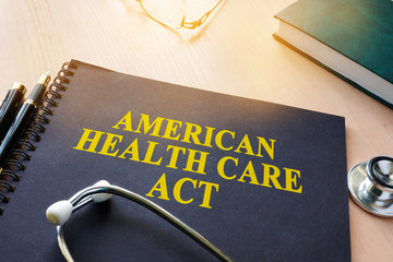 Book with title American Health Care Act and stethoscope.