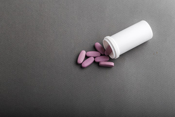 pills spilled out of a plastic jar