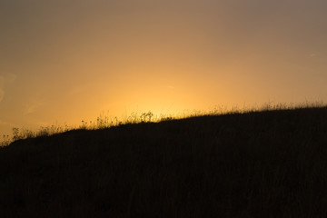 Sunset behind the hill