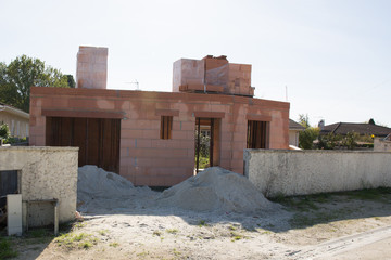 red brick house in pink under construction