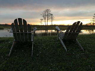 retirement and two chairs looking at the sunset in the swamp