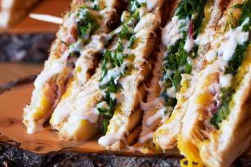 club sandwich on wood plate 