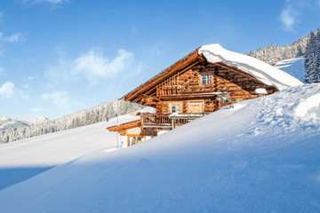Wooden mountain chalet lodge in the alps in winter
