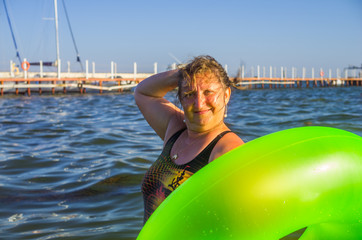 A woman is resting at vacation with buoy in a sea