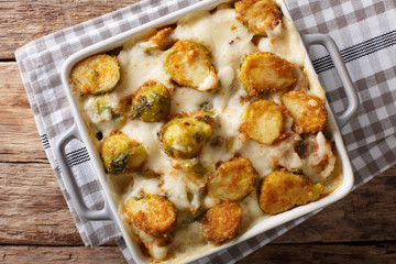Hot baked Brussels sprouts with garlic, cheese and cream sauce close-up. horizontal top view