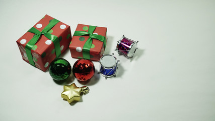 A glitter christmas decorations : santa claus, ornament, stars, drums and a present box on a white background with a copy space. Concept for Christmas celebrations.