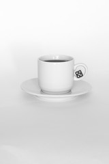 A cup of coffee with dice on white background