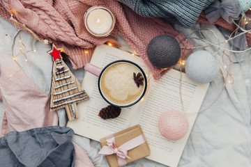 Fototapeta na wymiar Cup of hot coffee with wrapped present . Winter cozy mood. Flat lay