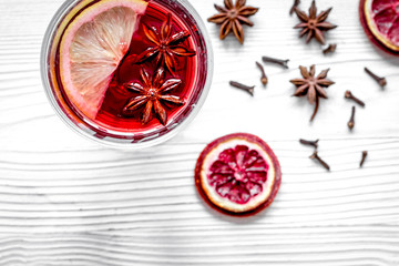 mulled wine with spices in cup wooden background top view