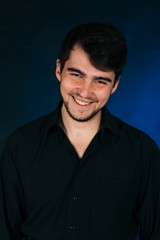 Obraz premium young brunette guy on a dark background