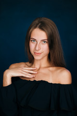 Portrait beautiful girl on a dark studio background