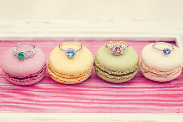 Luxury engagement rings on sweet little macarons