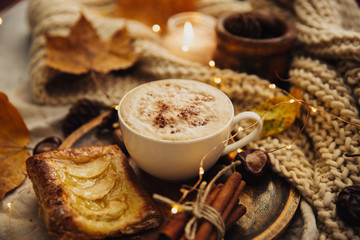 Autumn Cozy fall background with hot coffee cup and decorations. Hipster blogger morning