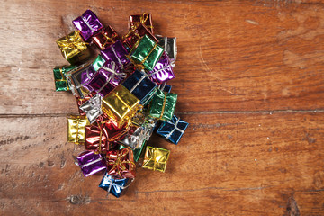 large number of small gifts on a wooden table, top view