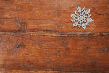 Snowflake on wood, copy space 