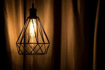 Yellow lamp hanging with curtain background