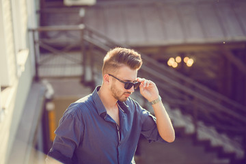 handsome young man in sunglasses outdoors