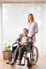 Health visitor and a senior woman during home visit.