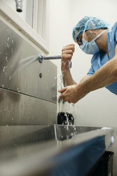 Surgeon washing hands before operation
